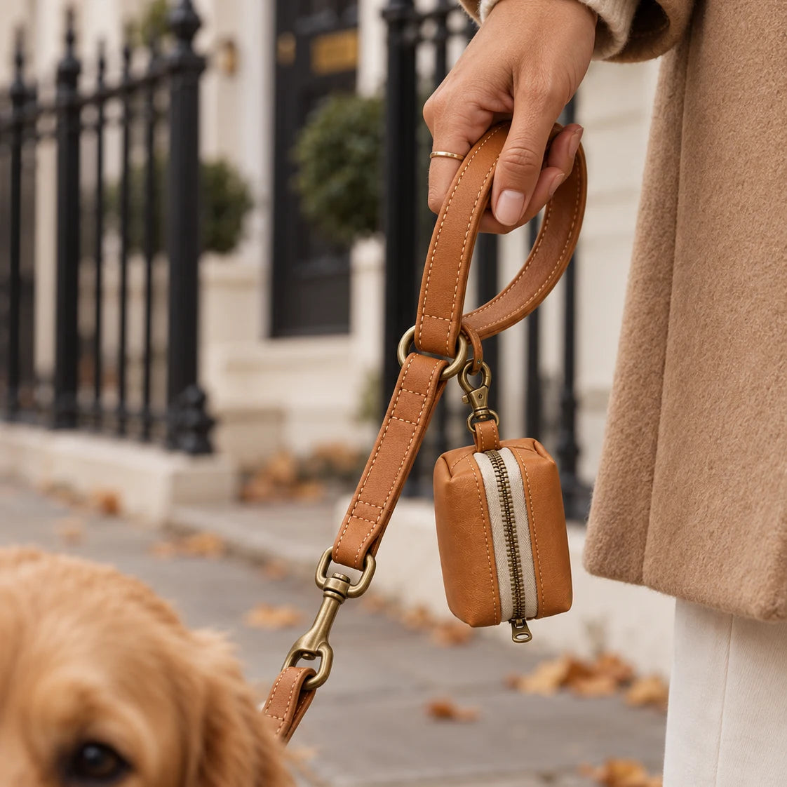 Close-up of the Marylebone lead and zip poop bag holder in Saddle